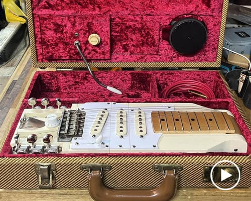 foldable electric guitar for travel fits inside briefcase that has built-in speaker and amplifier